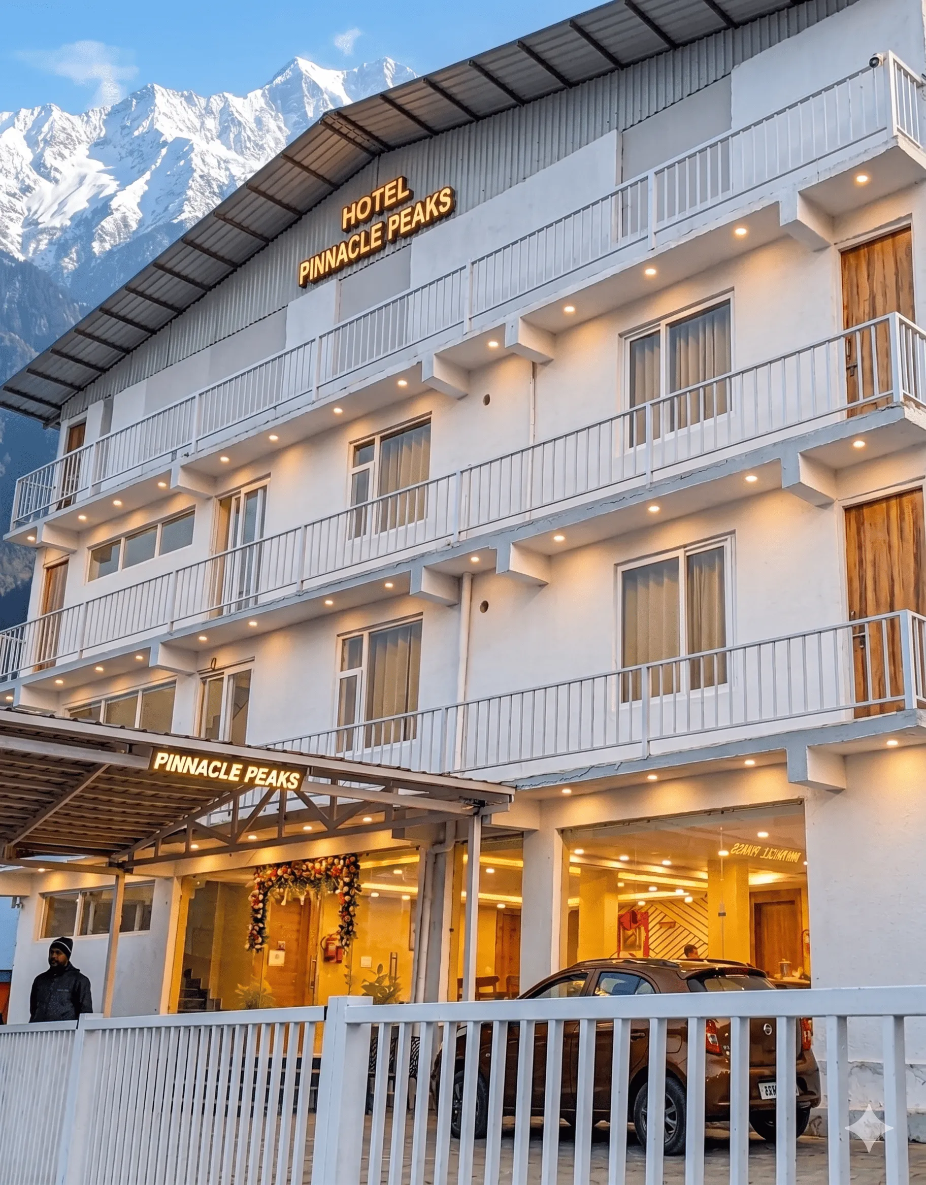 Hotel Pinnacle Peaks exterior against the Himalayan skyline